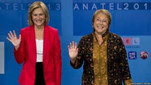 Chilean presidential candidates Michelle Bachelet and Evelyn Matthei wave to the media during a live televised debate in Santiago