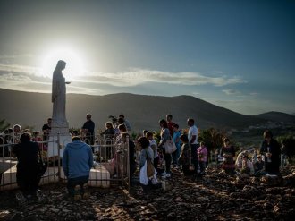 Picture of pilgrims visiting Virgin Mary statue at Medjugorje in Bosnia and Herzegovina