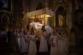 Picture of Roman Catholic youths guarding a life-size figure of Mary at the Feast of the Assumption in Kalwaria Paclawska, Poland